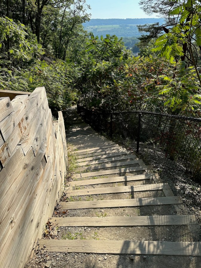 Long staircase descending to parking lot.