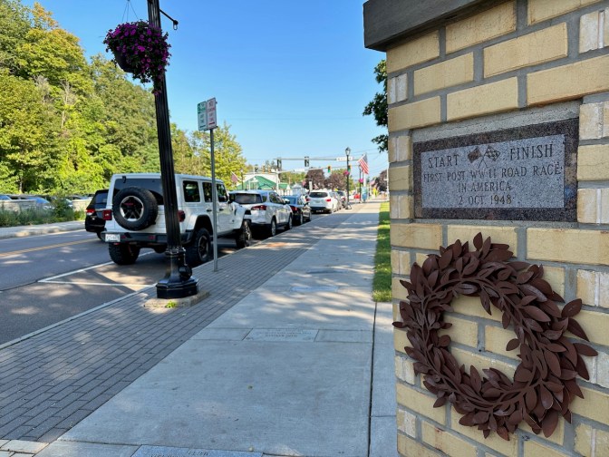 Start/finish line marker beside road.
