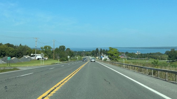 View of Seneca Lake in distance from road.
