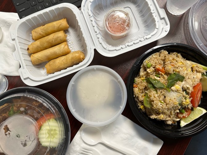 Thai fried rice, spring rolls, and other foods on