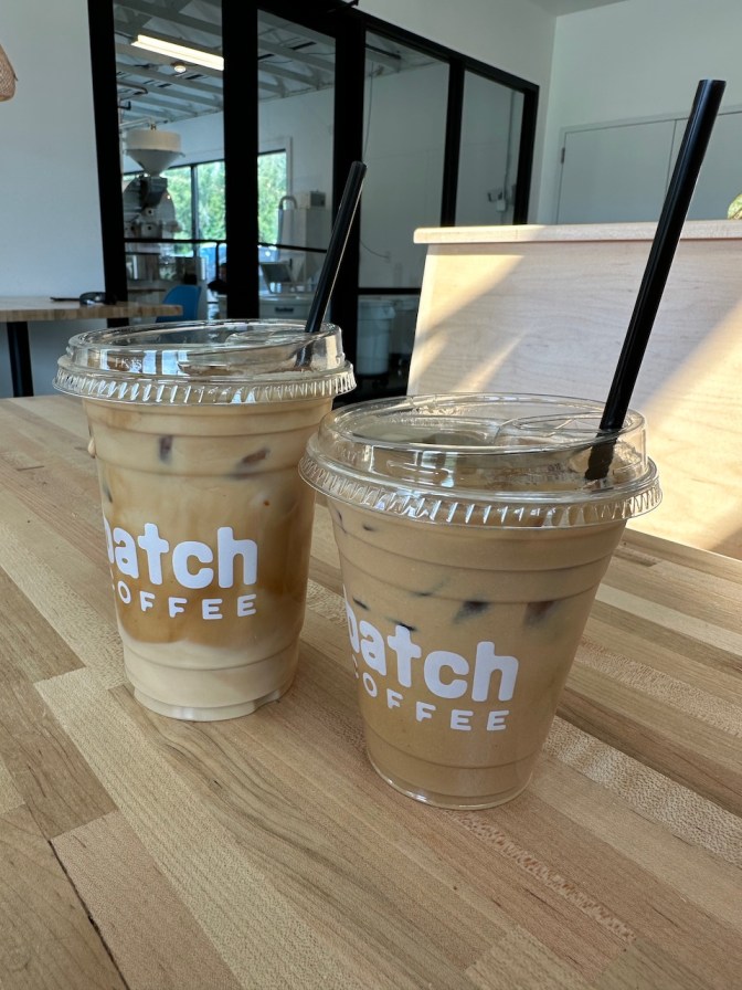 Two iced lattes on counter of Batch Coffee.
