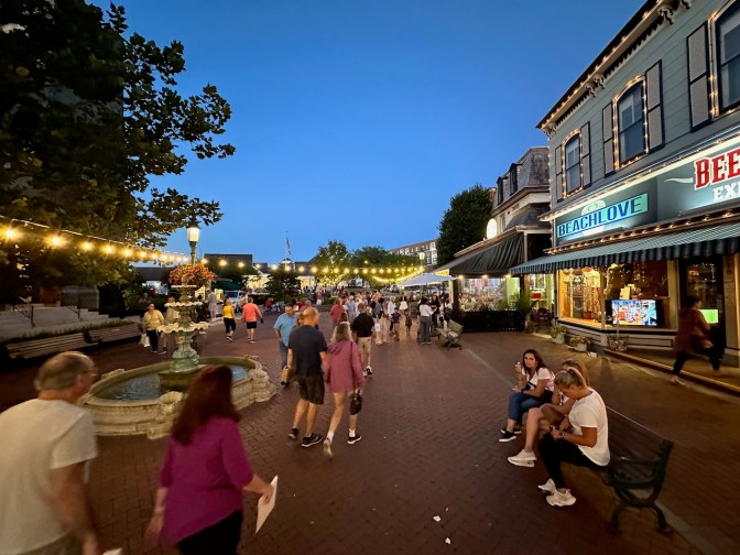 Visitors walking through Washington Street Mall at night.