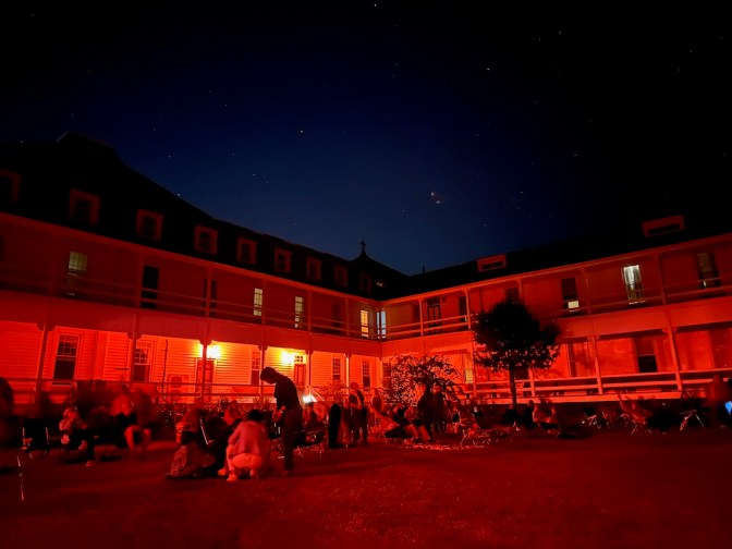 View of people sitting in front of science center.