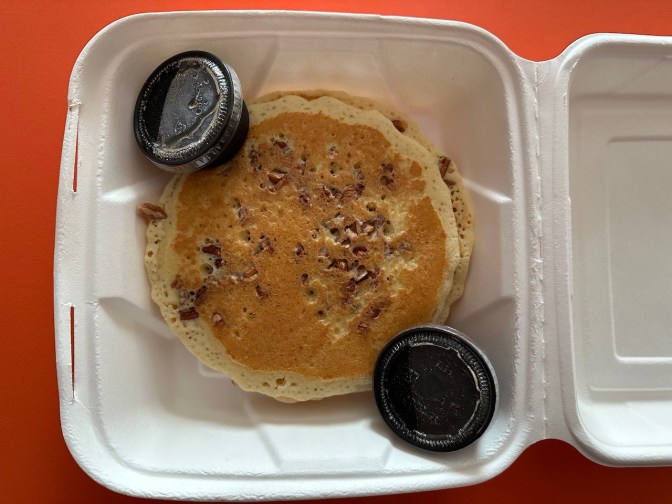Pecan pancakes in takeout container.