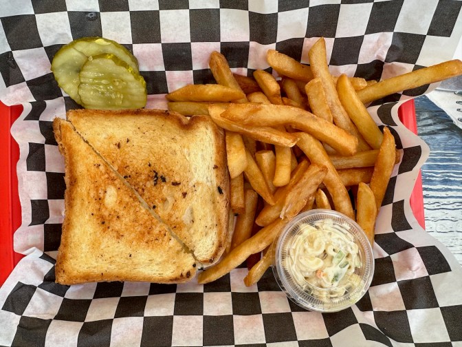 Grilled cheese and French fries in basket.