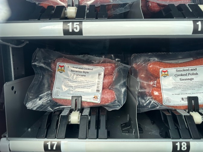 Packages of bratwurst and cooked sausage in vending machine.
