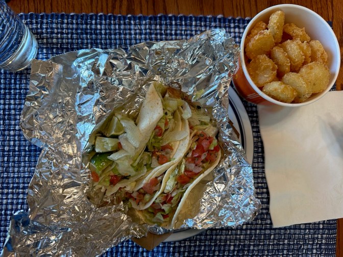 Tacos and container of potato oles from