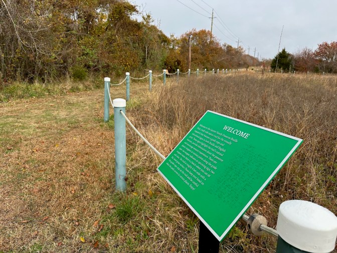 Entrance to Braille Trail at preserve, with signage.