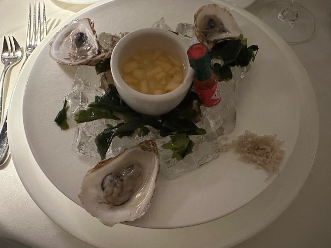 Plate with oysters and mignonette sauce.