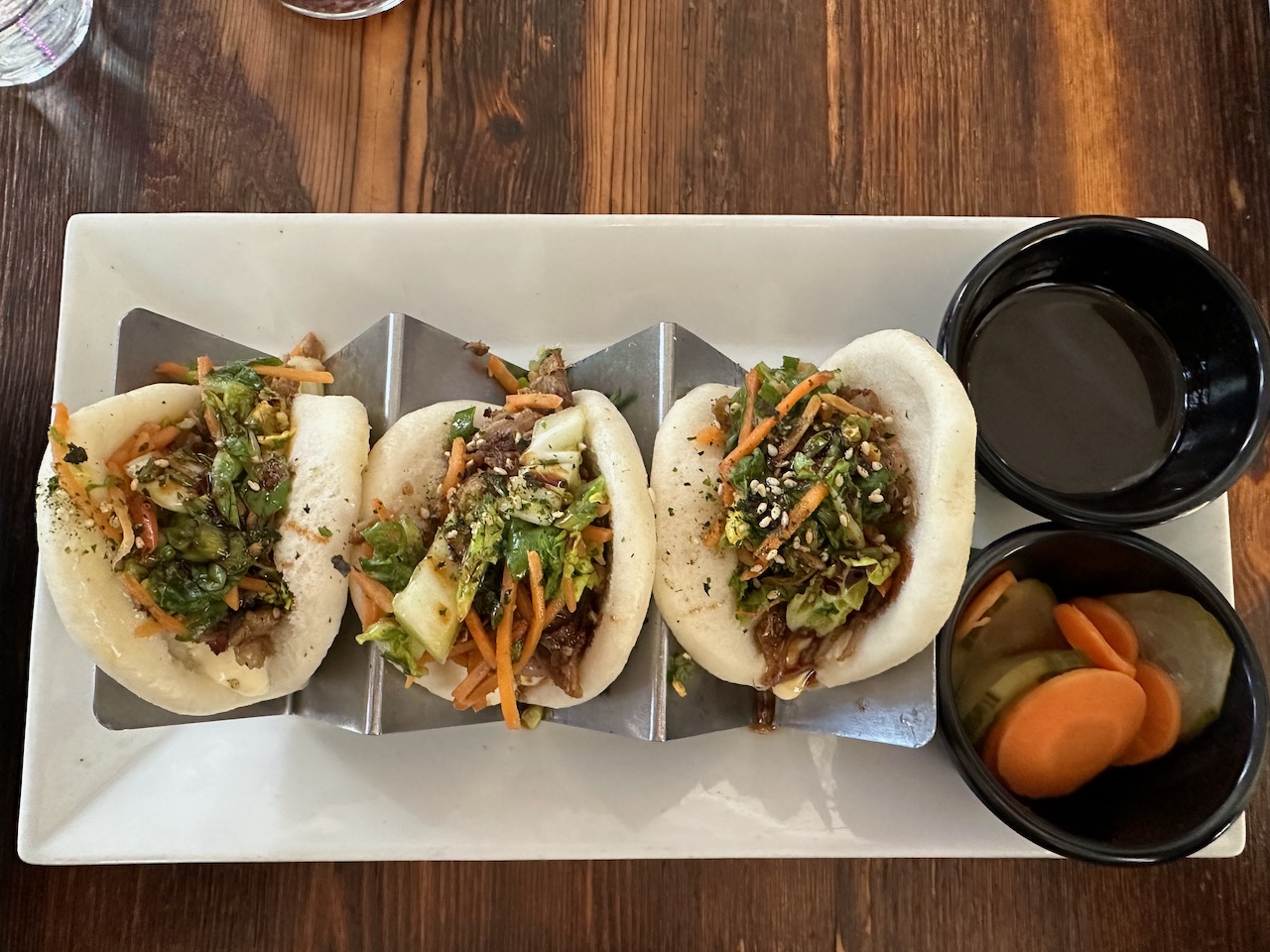 Duck fonfit buns on white plate.