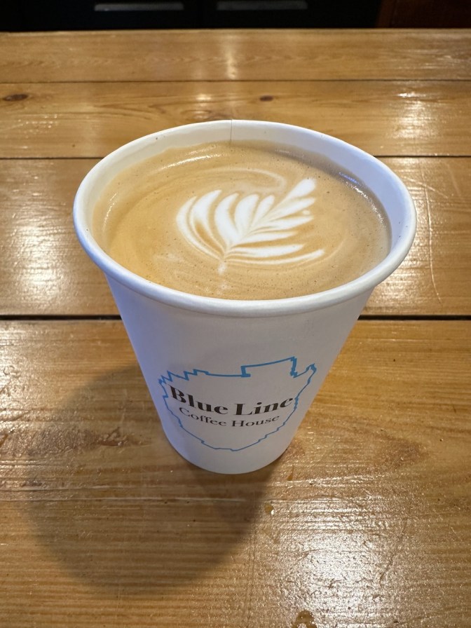 Latte with latte art on table.