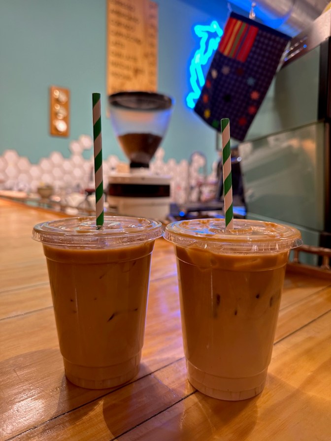 Iced lattes on wooden table.