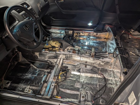 Interior of 2003 Honda Accord with seats and carpets removed.