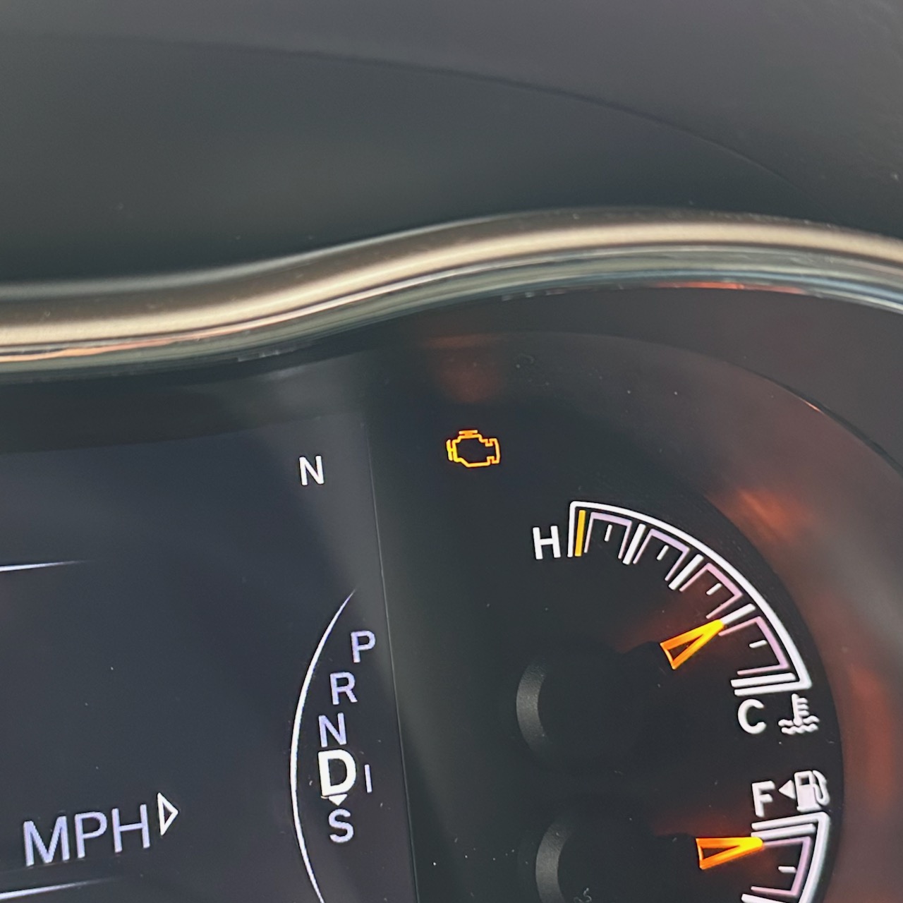 Jeep Grand Cherokee gauge cluster with check engine light illuminated.
