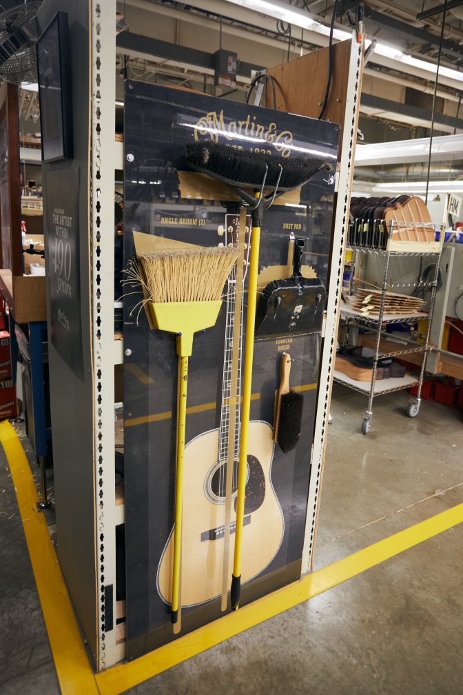 Display with brooms and dustpan for factory.