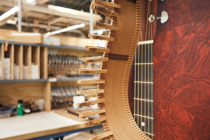 Clothespins holding framing on guitar.