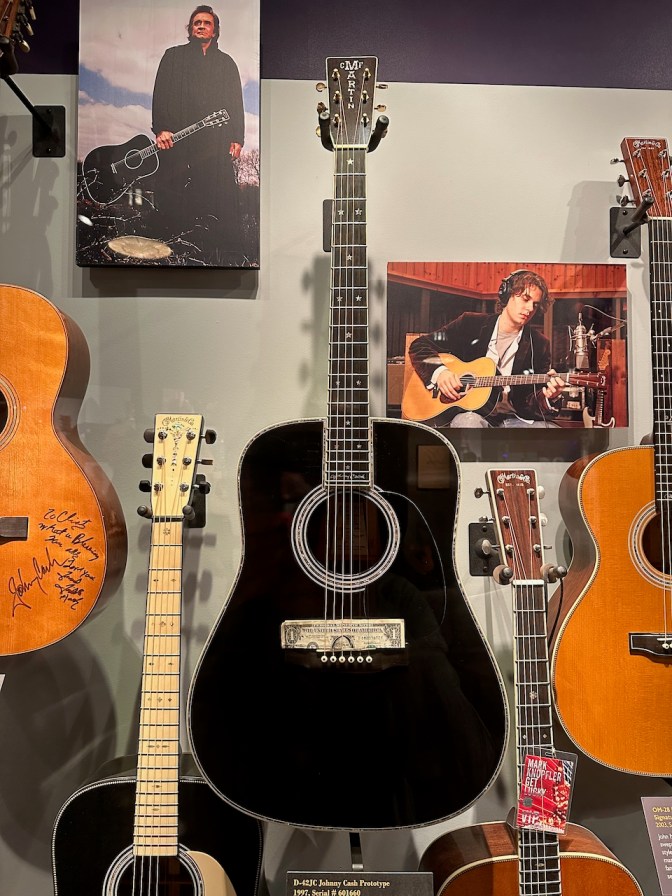 Black acoustic guitar on display.
