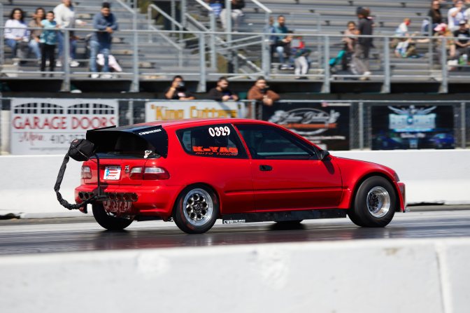 Honda Civic running on race track.