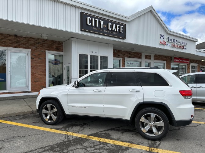 2014 Jeep Grand Cherokee parked in front of City Cafe.