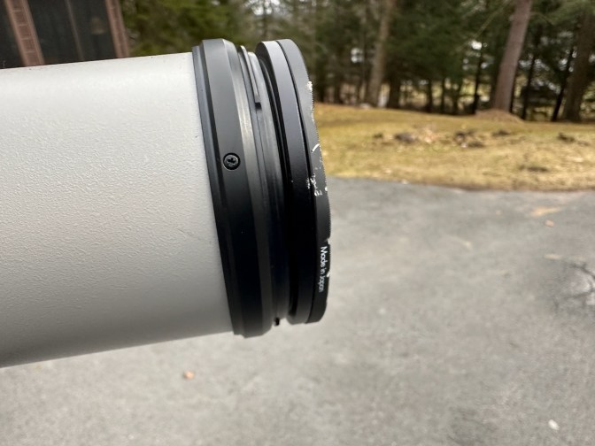 Front of camera lens with damaged filter.