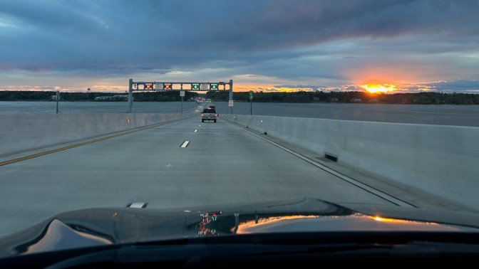 View of Nice-Middleton Bridge, with sun setting over Potomac River.