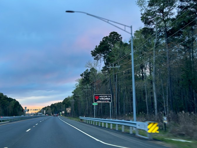 WELCOME TO VIRGINIA sign beside road.