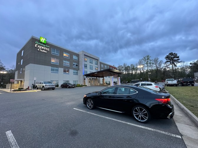 2020 Acura TLX parked in front of Holiday Inn Express & Suites hotel.