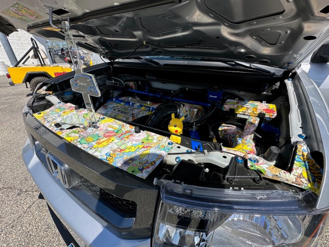 Honda Element engine bay covered in Pokemon-themed decorations.