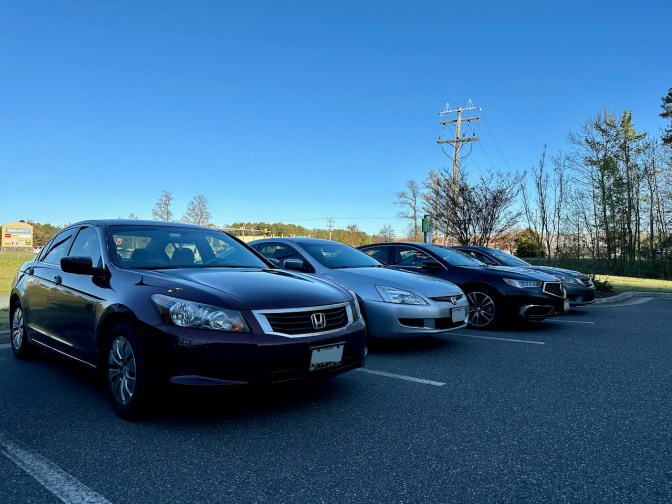 Three Honda Accords and an Acura TLX, parked in a row.