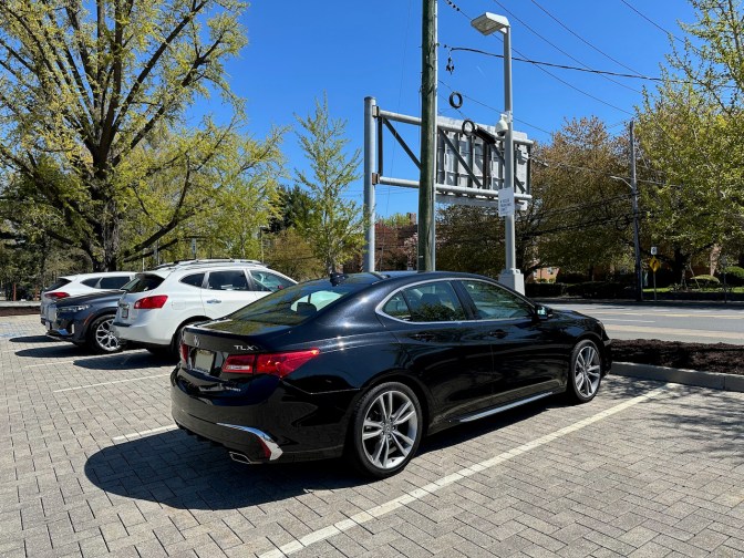 Acura TLX parked in brick parking lot.