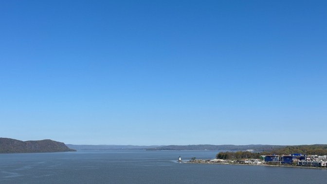 View of Hudson River, facing north. The Tarrytown coastline and a lighthouse are in foreground on right.