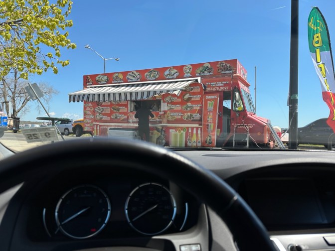 View of food truck through windshield of Acura TLX.