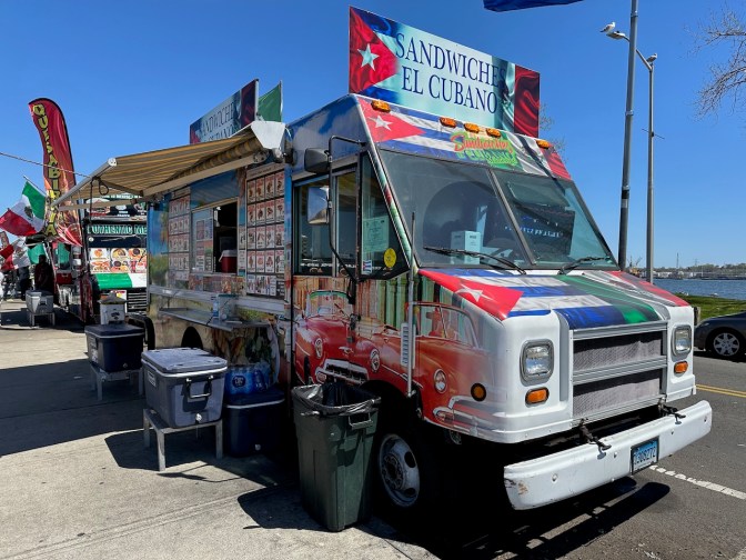 White food truck with sign on top that says SANDWICHES EL CUBANO.