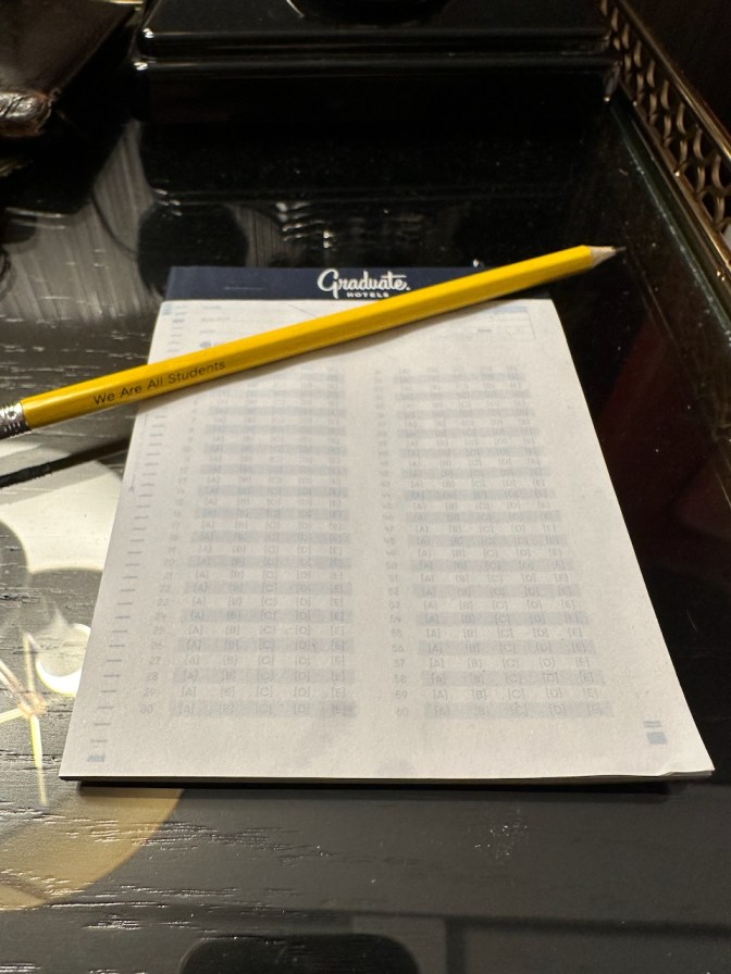 Notepad on table, with scantron answer sheet design.