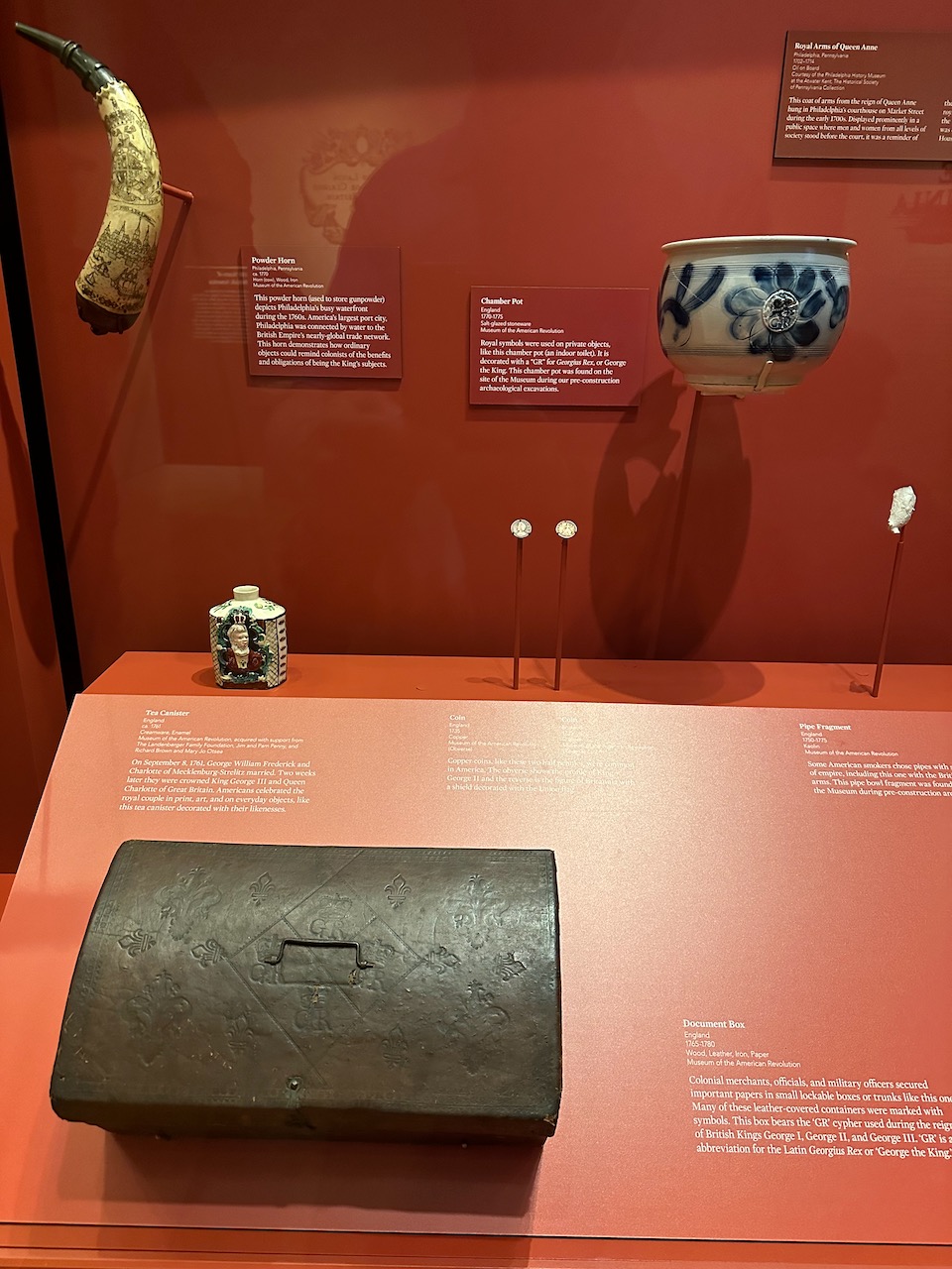 Objects such as powder horn, bowl, and ink stand emblazoned with initials for King George III.