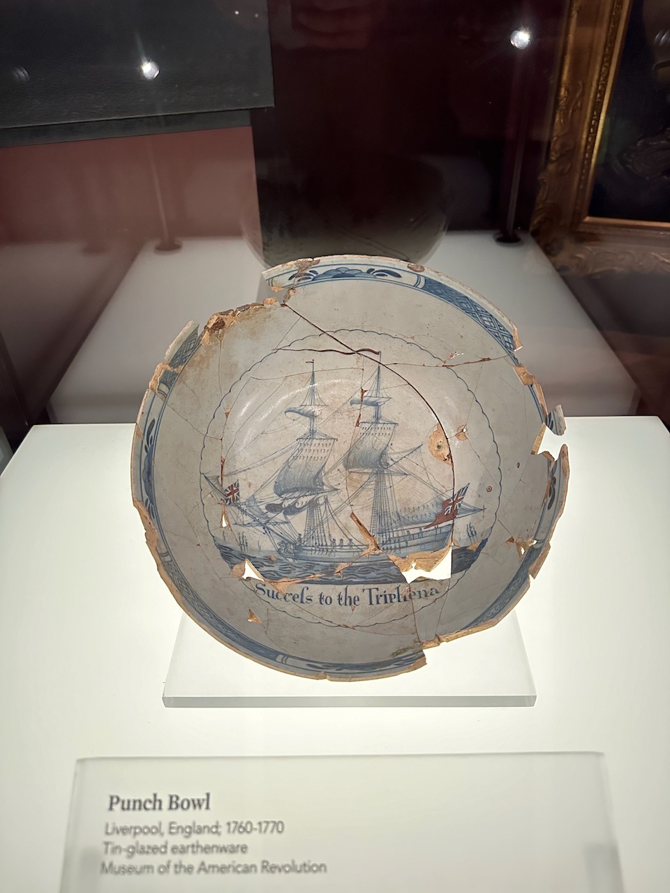 White punch bowl with drawing of sailing ship within bowl.