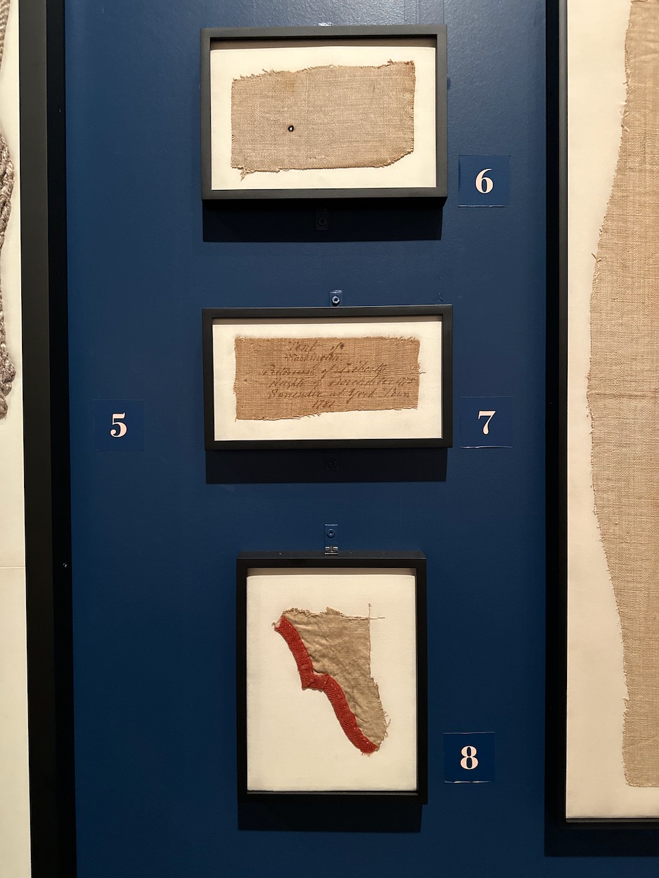 Four frames with scraps of material from Washington's tents.