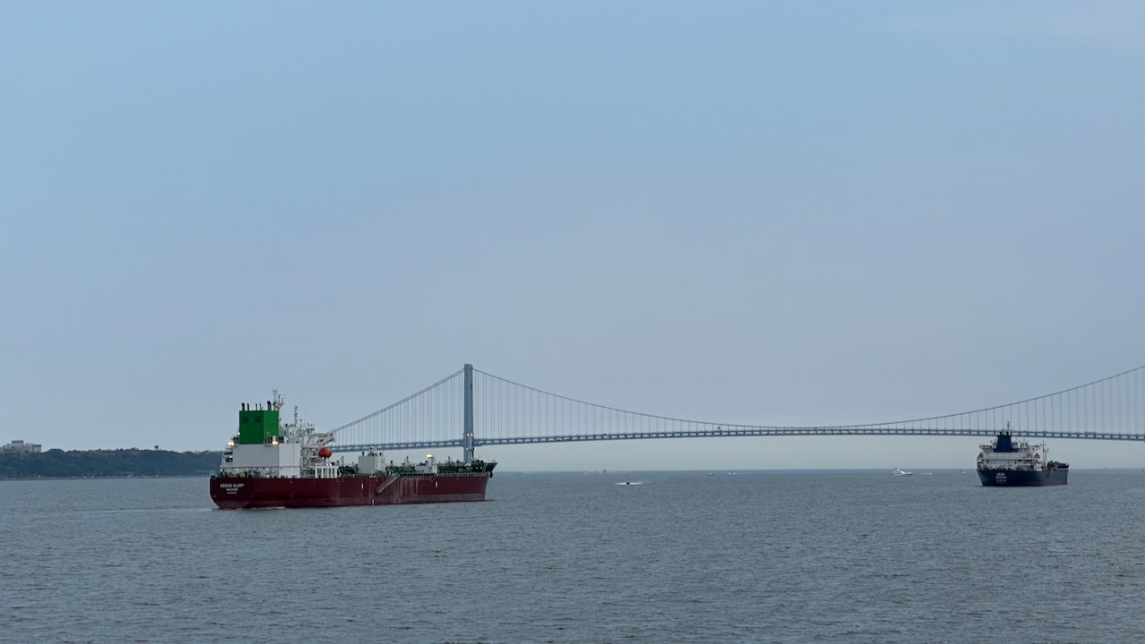 Two tankers on New York harbor. A large bridge is in the background.