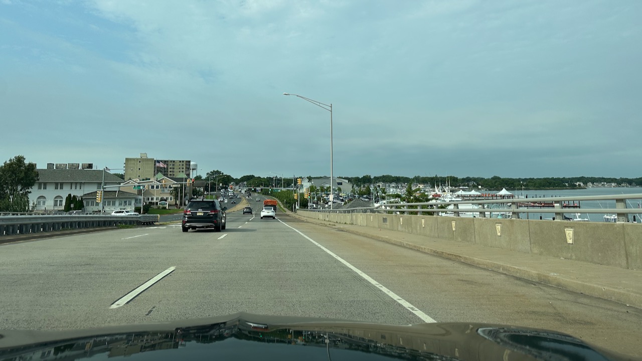 Bridge entering Belmar, NJ. A dock is to the right of the bridge.