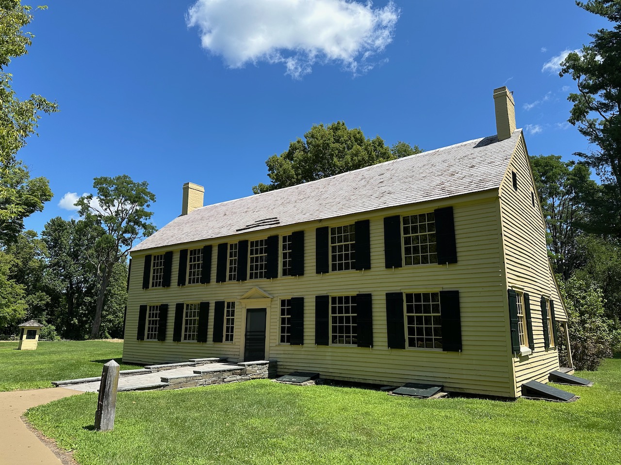 Exterior of Schuyler House, a yellow, two story home.