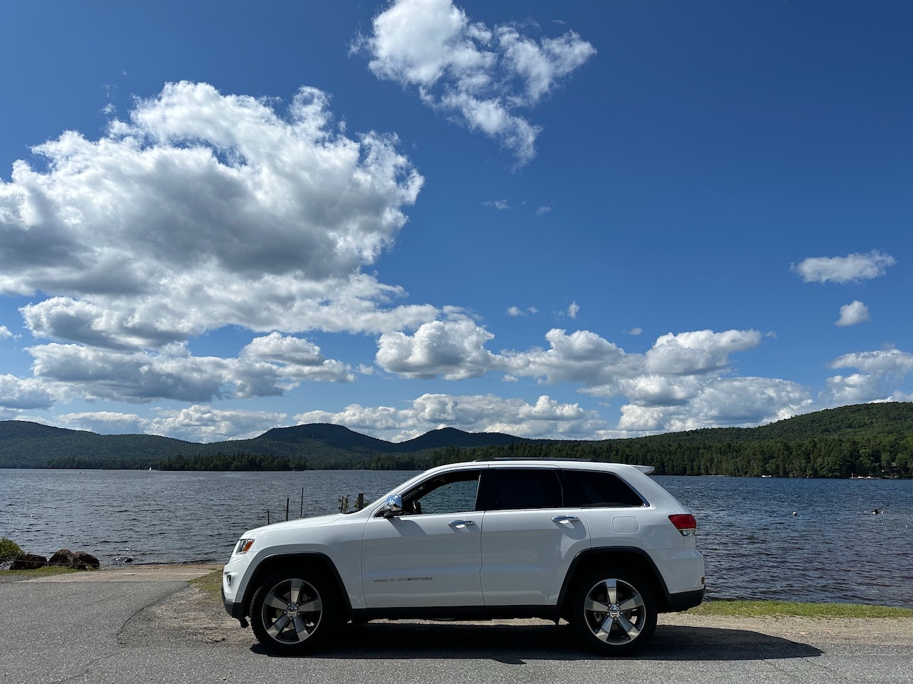 2014 Jeep Grand Cherokee, parked in front of Blue Mountain Lake.