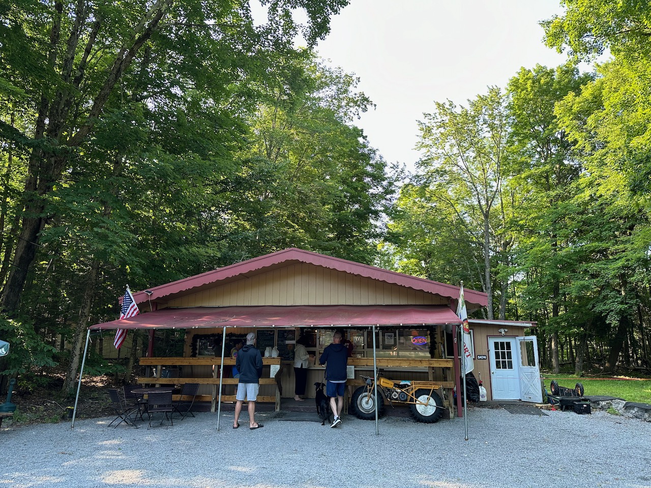 Exterior of The Eagle Bay Donut Shop, with people standing in line to order.