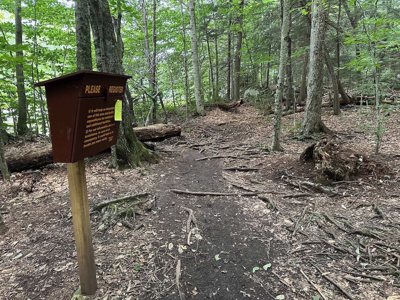 Trailhead register in woods.
