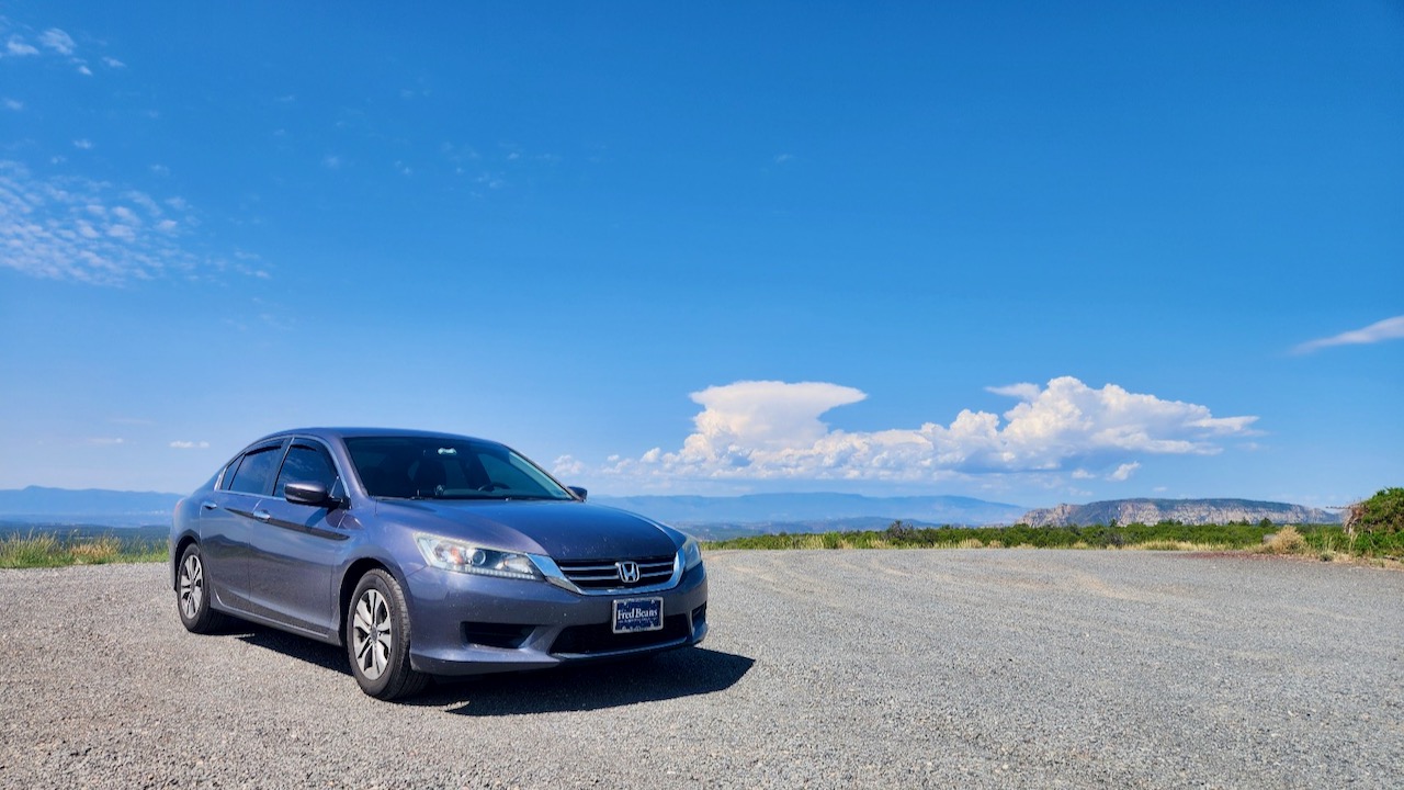 2014 Honda Accord parked on gravel lot, with mountains in distance.
