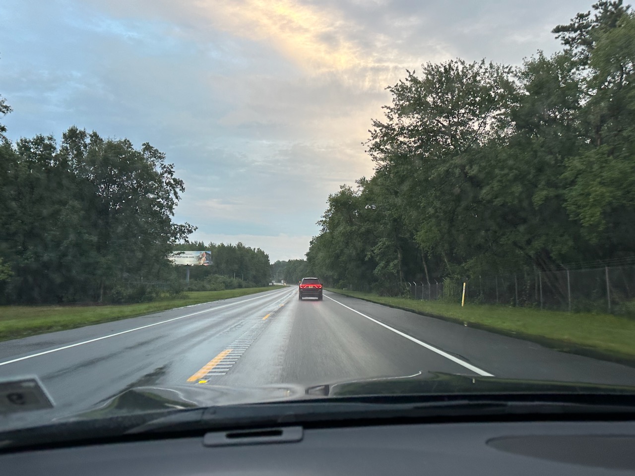 View of two-lane highway through woods.