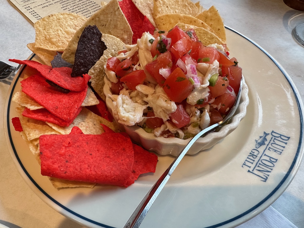 Crab meat appetizer on white plate.