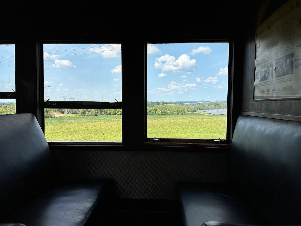 View of landscape through windows of train.