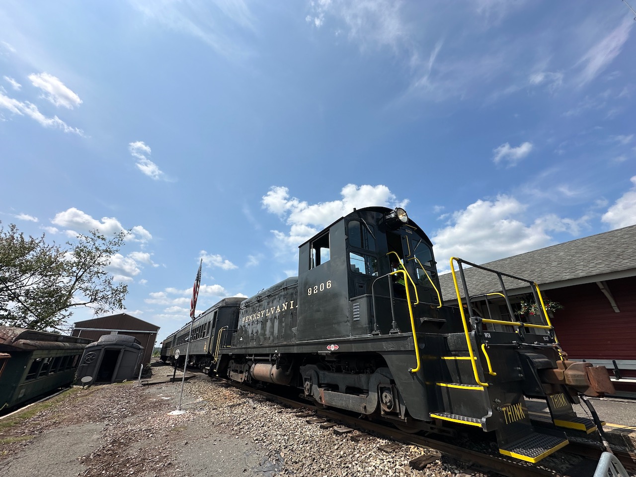 Diesel locomotive and passenger cars at Ringoes station.
