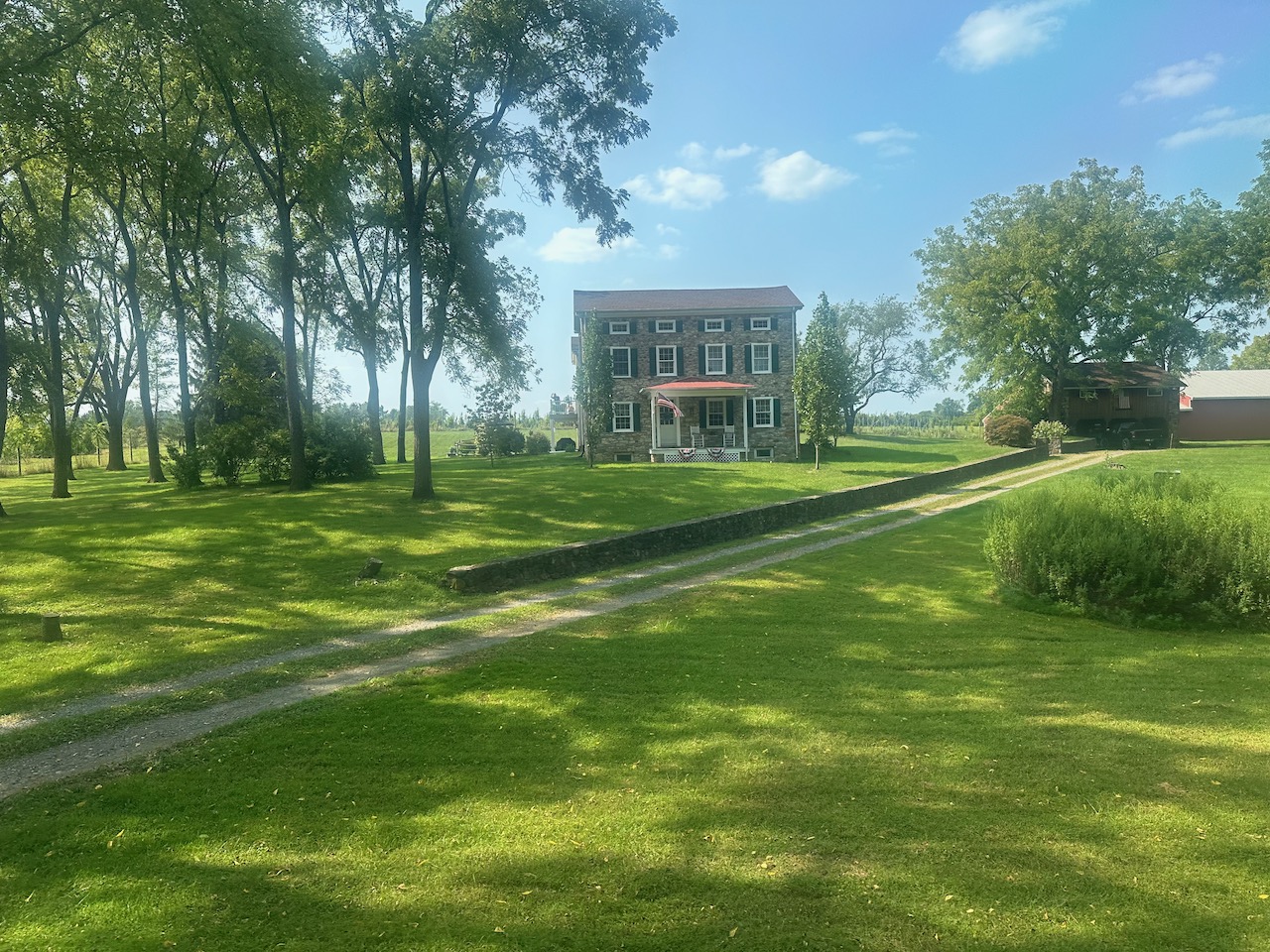 View of old stone house in field.