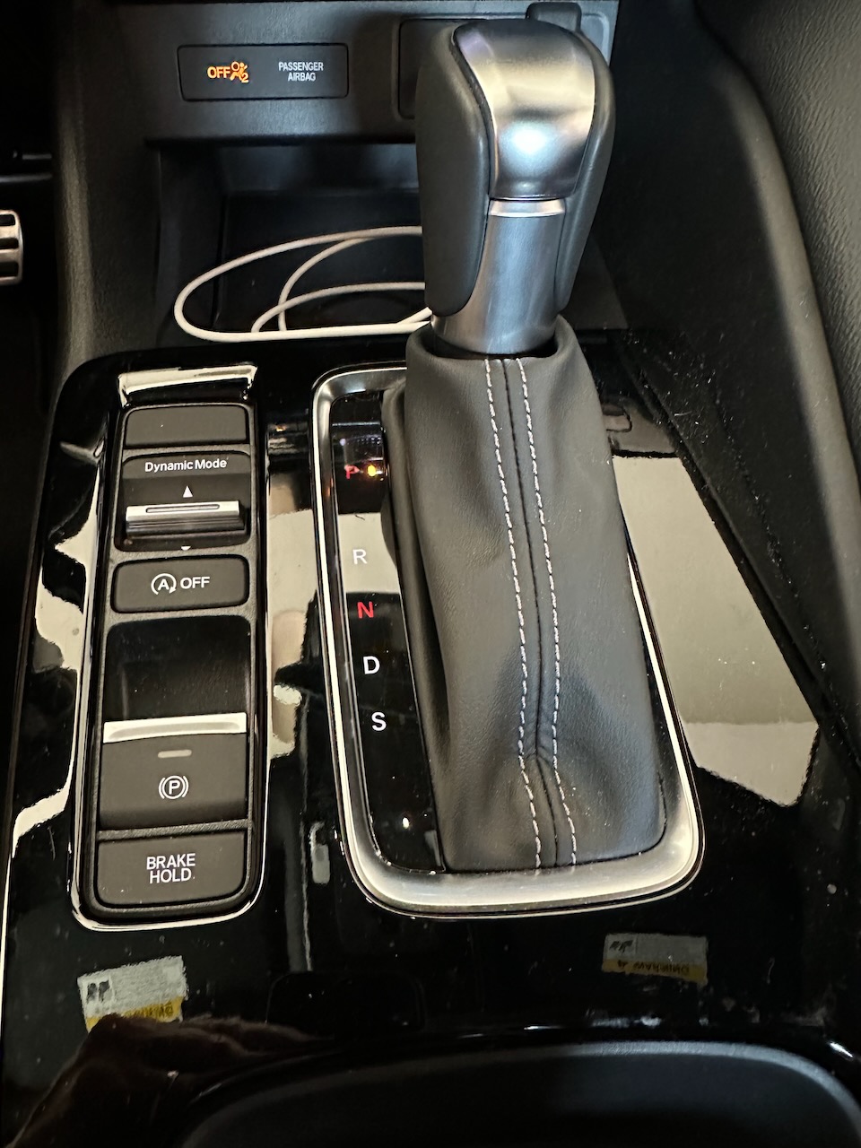 Gear shift and associated buttons on central tunnel of interior.